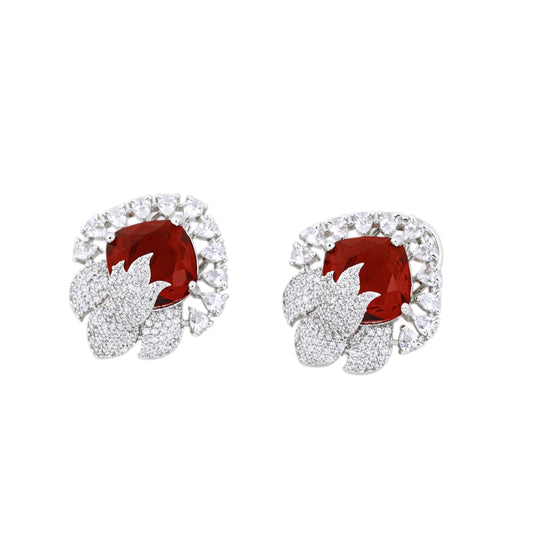 Pair of earrings with red gemstones and diamond-like stones on a white background