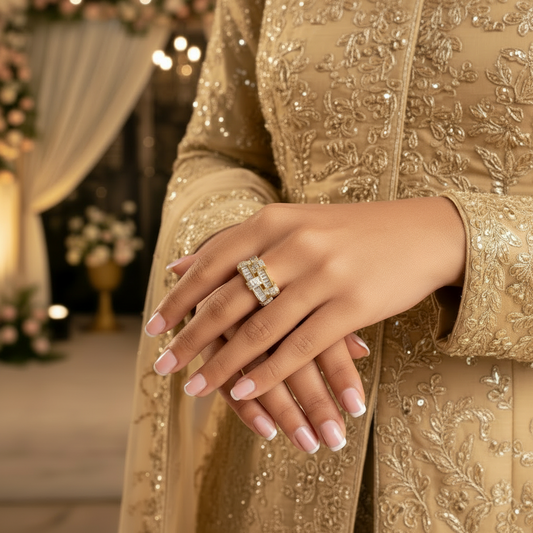Hand wearing a gold ring with diamonds on a white background