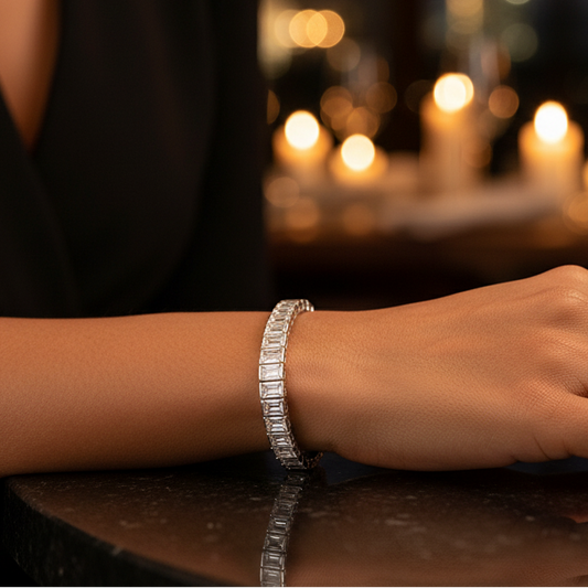 Silver bracelet on a wrist with a blurred candlelit background