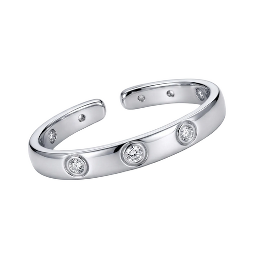 Silver bracelet with embedded diamonds on a light gray background