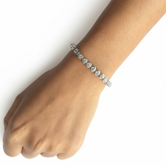 Close-up of a hand wearing a bracelet on a purple fabric background