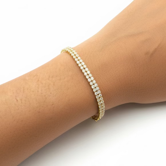 Close-up of a hand wearing a bracelet on a purple fabric background