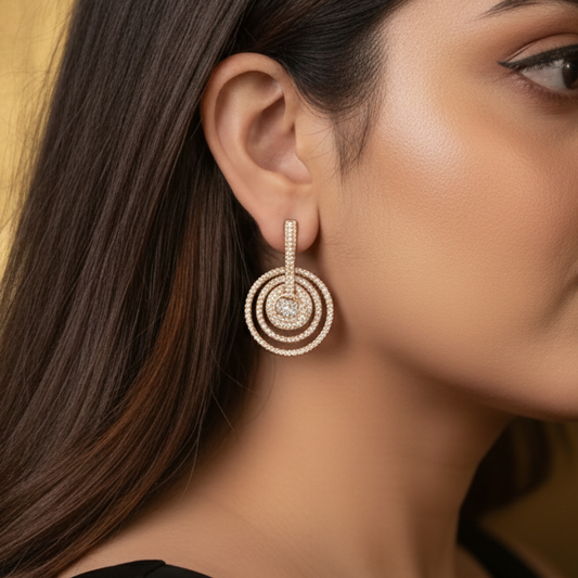 Close-up of a woman wearing gold earrings with a blurred background