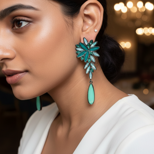 Woman wearing turquoise earrings in a softly lit indoor setting
