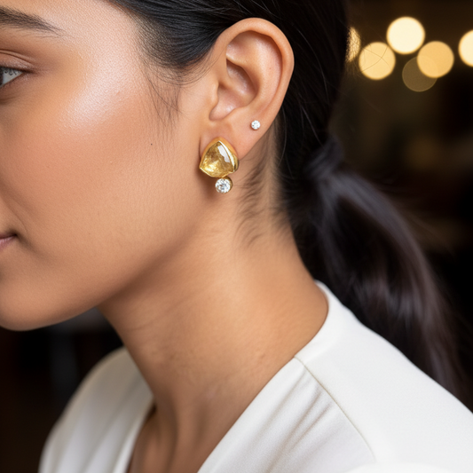 Close-up of a woman wearing gold earrings with a blurred background
