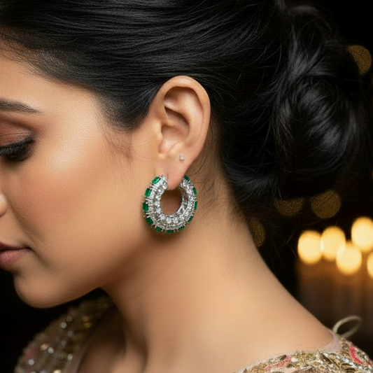 Woman wearing a green earring with a blurred lights background