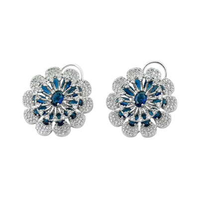 Pair of floral earrings with blue gemstones on a white background