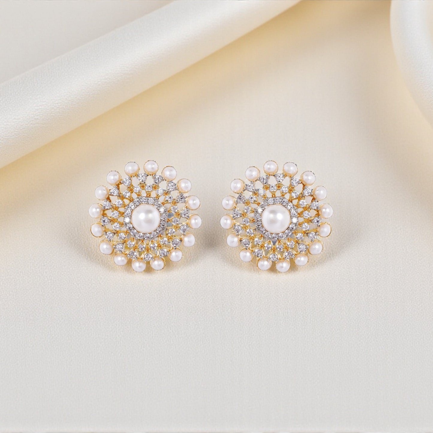 Pair of pearl earrings on a light beige surface