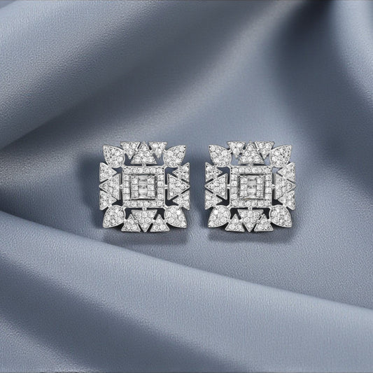 Pair of diamond earrings on a textured gray fabric background