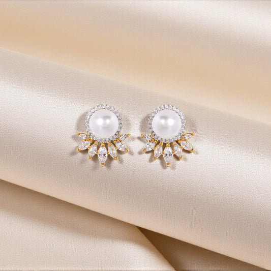 Pair of pearl earrings on a satin surface