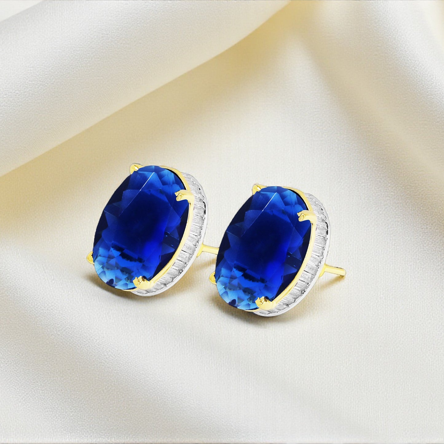 Pair of earrings with blue gemstones on a beige background