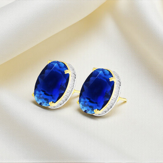 Pair of earrings with blue gemstones on a beige background