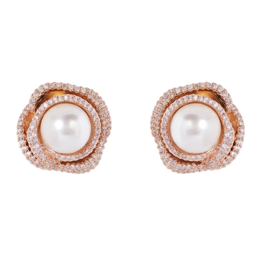Pair of earrings with pearls and rose gold accents on a white background