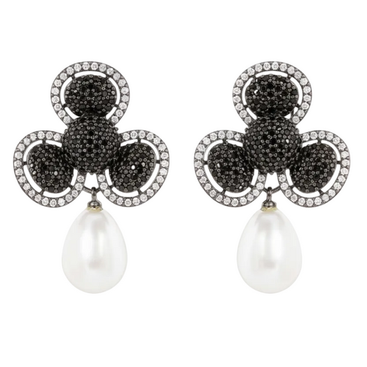 Pair of earrings with black gemstones and pearl drops on a white background