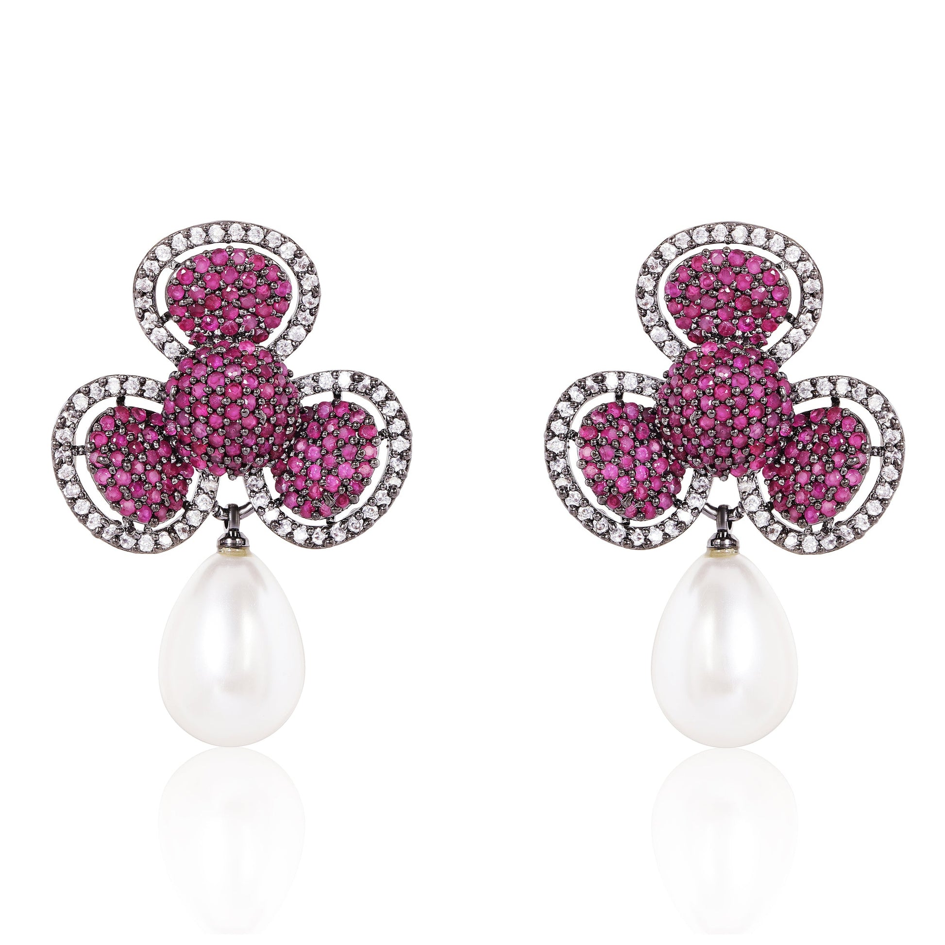 Pair of earrings with pink gemstones and pearl drops on a white background