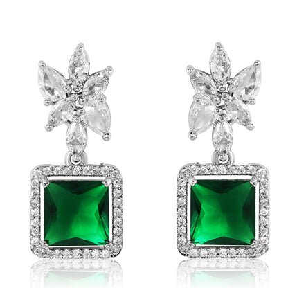 Pair of earrings with butterfly designs and green gemstones on a white background