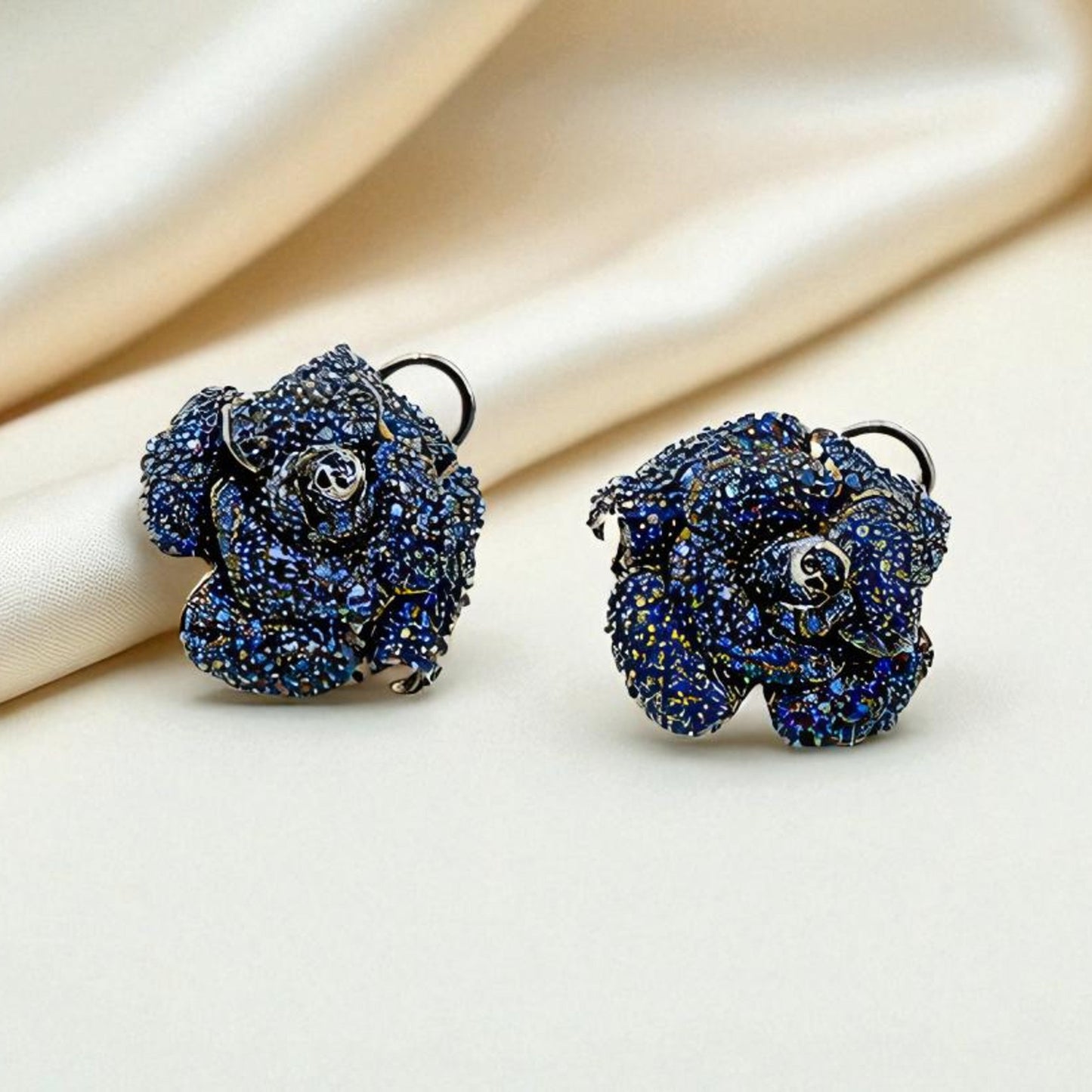 Blue rose-shaped earrings on a beige fabric background