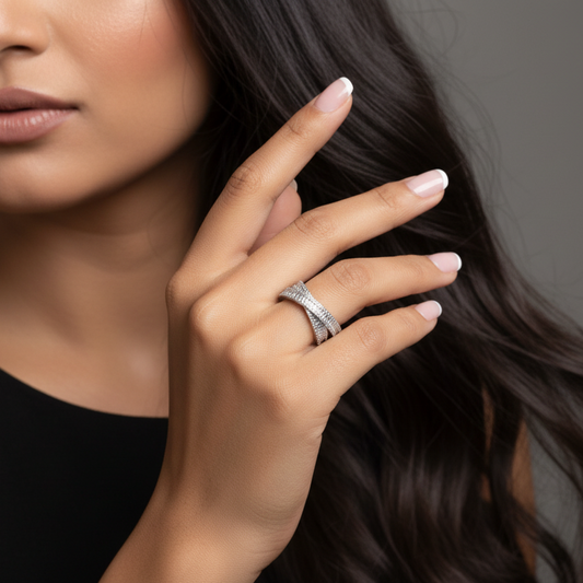 Close-up of a woman's hand wearing a ring with a gray background
