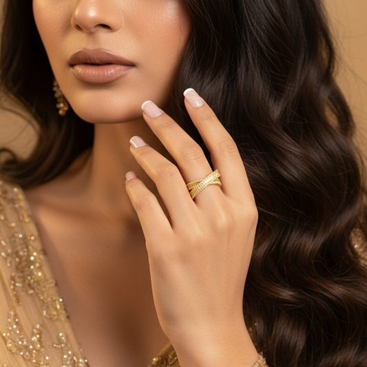 Woman wearing a gold dress and ring with a neutral background