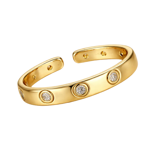 Gold bracelet with diamond accents on a white background