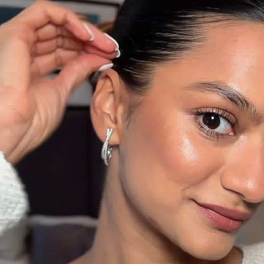 Woman adjusting an earring with a blurred background