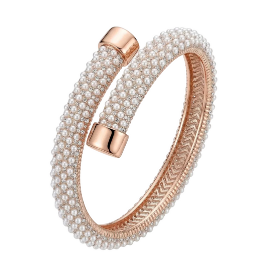 Pearl bracelet with rose gold accents on a white background