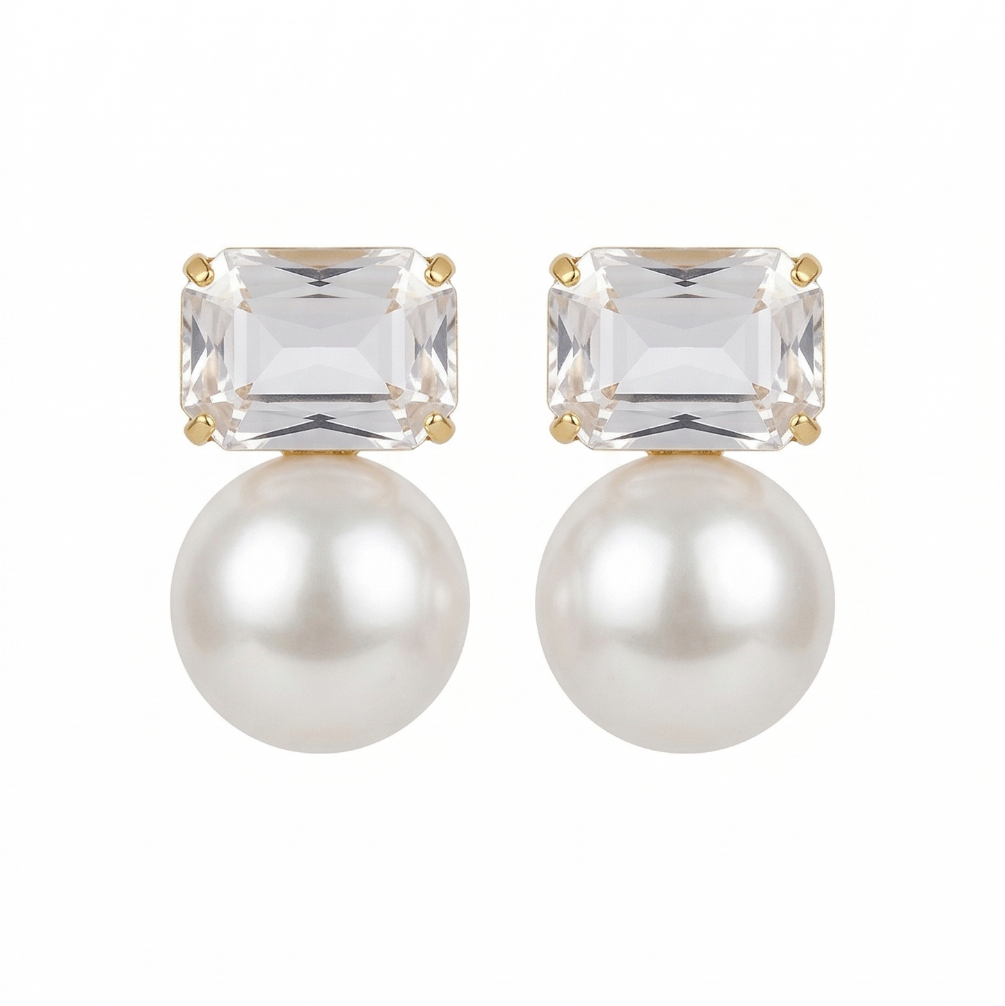 Pair of earrings with clear gemstones and pearls on a white background
