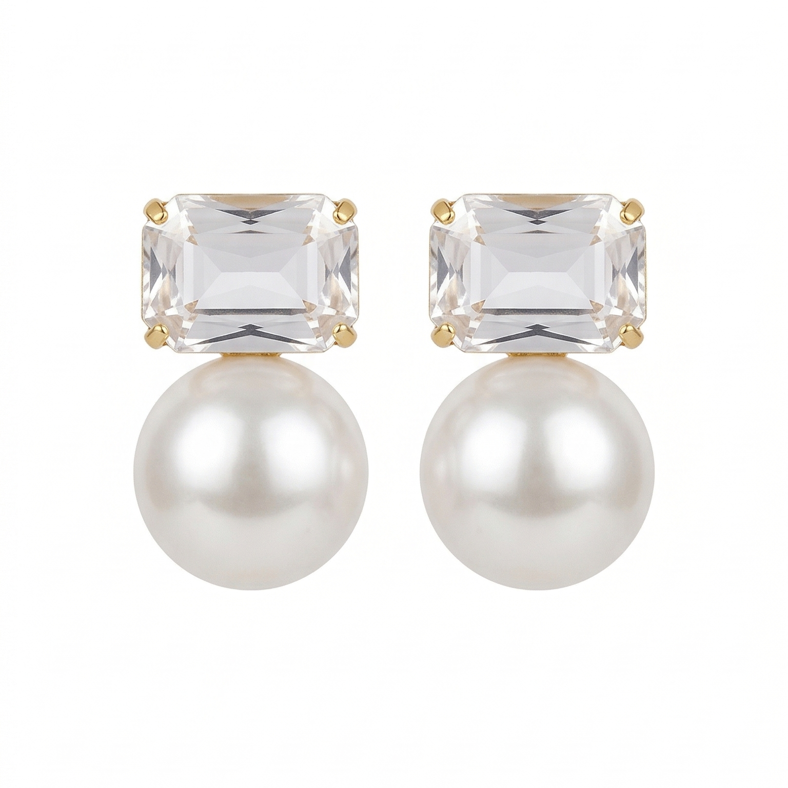 Pair of earrings with clear gemstones and pearls on a white background