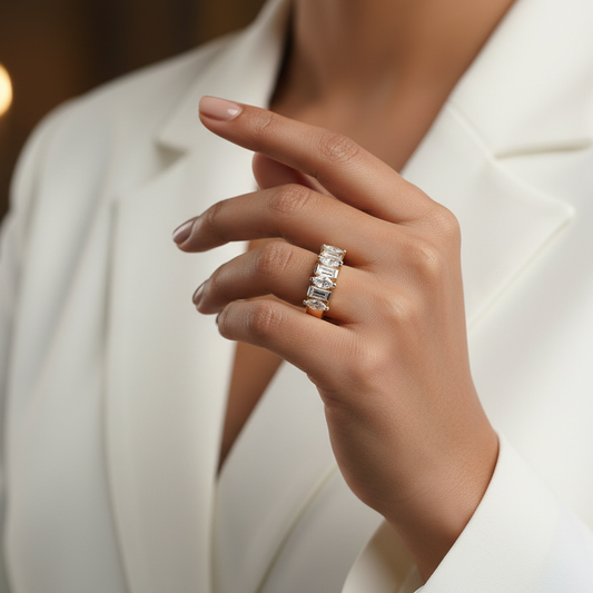 Close-up of a hand wearing a diamond ring with a blurred background