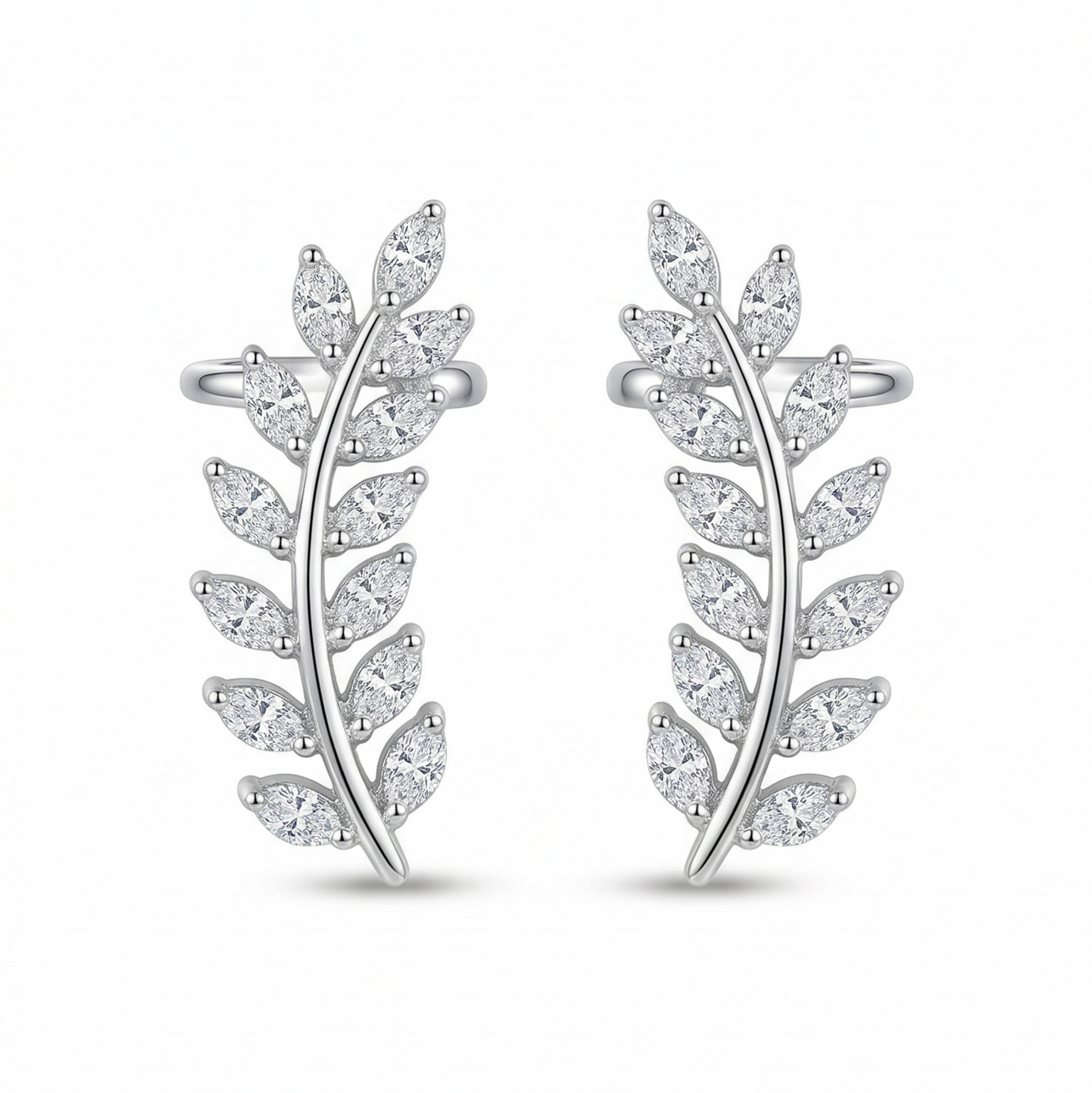 Pair of silver leaf-shaped earrings on a white background