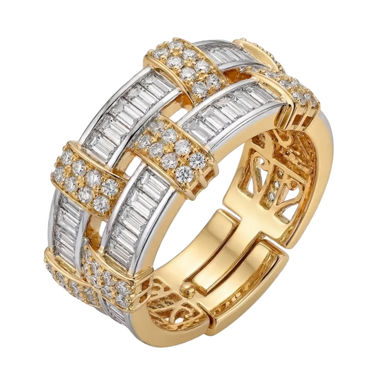 Gold and silver ring with intricate design on a white background