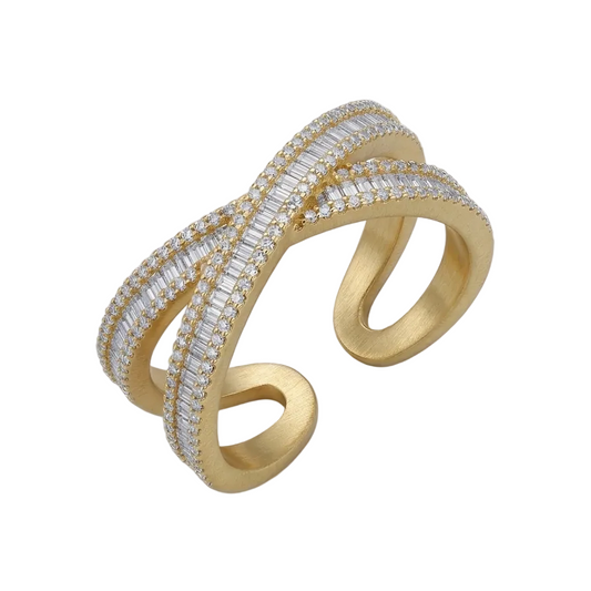 Gold and diamond ring on a light gray background