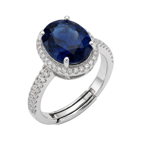 Silver ring with a blue gemstone on a white background