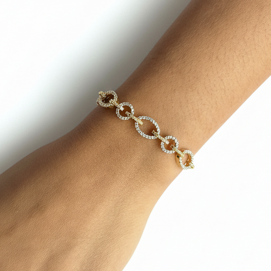 Bracelet on a person's wrist against a purple fabric background