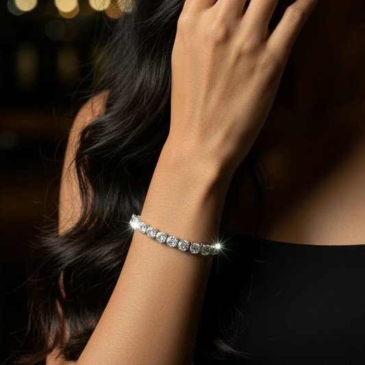 Diamond bracelet on a wrist with a purple fabric background