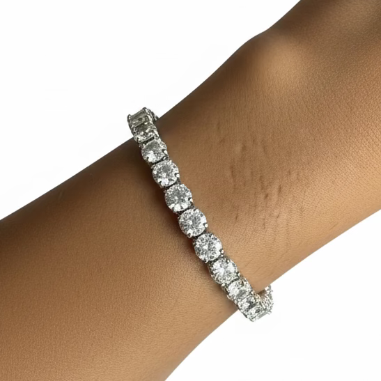 Diamond bracelet on a wrist with a purple fabric background