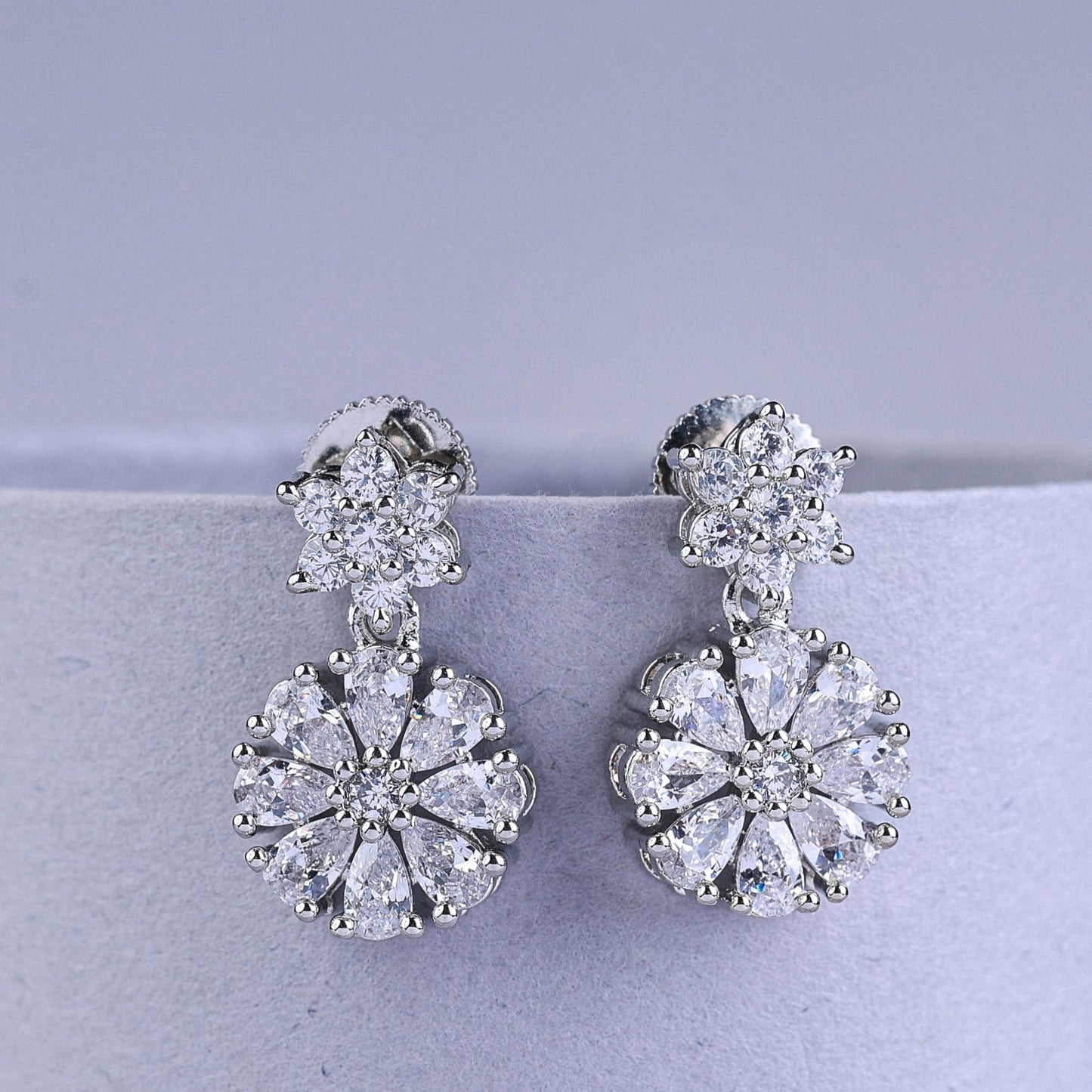 Silver earrings with butterfly designs and square gemstones