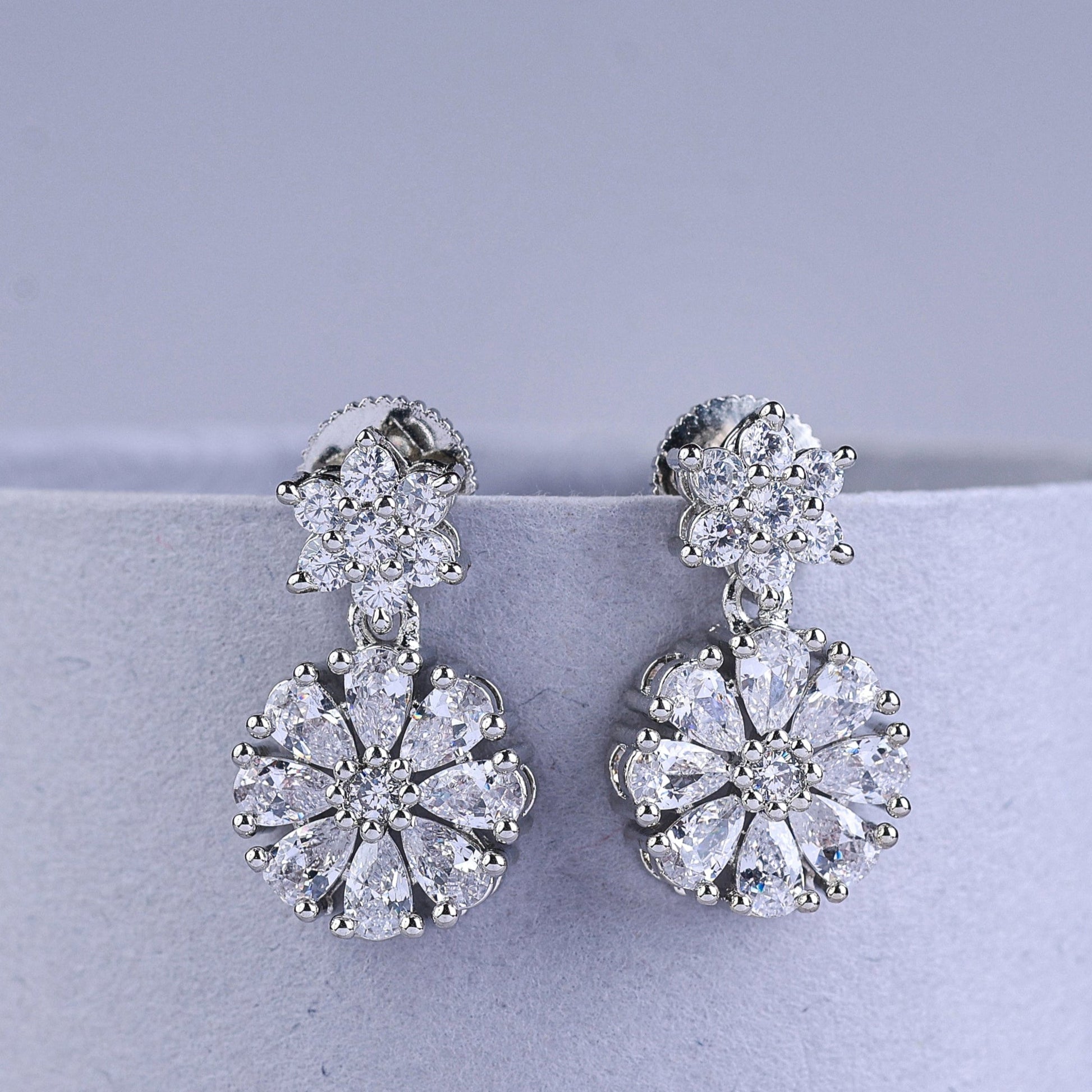 Silver earrings with butterfly designs and square gemstones