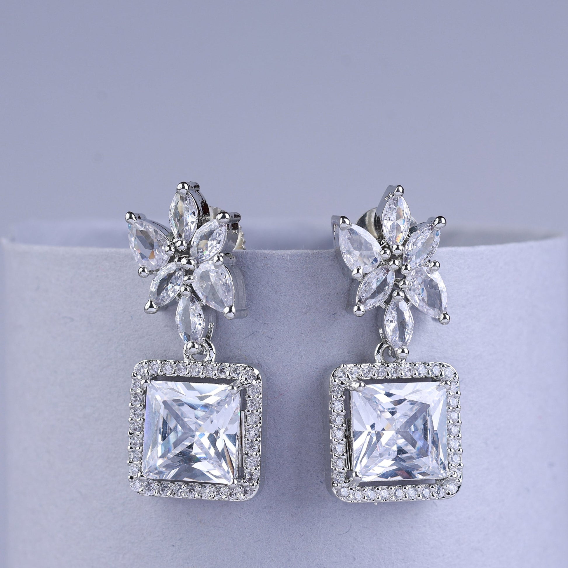 Silver earrings with butterfly designs and square gemstones