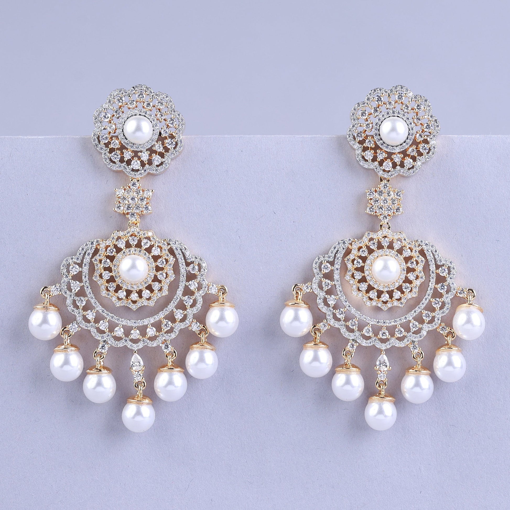 Pair of ornate earrings with pearls 