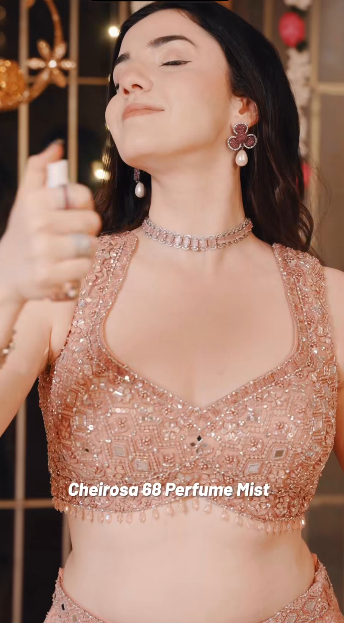 Woman holding a spray bottle labeled 'Cheirosa 68 Perfume Mist' with a blurred background