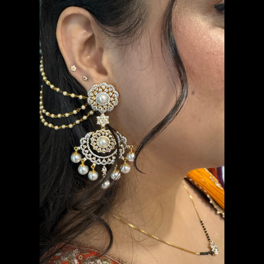 Close-up of a woman wearing ornate earrings and a necklace with intricate designs.