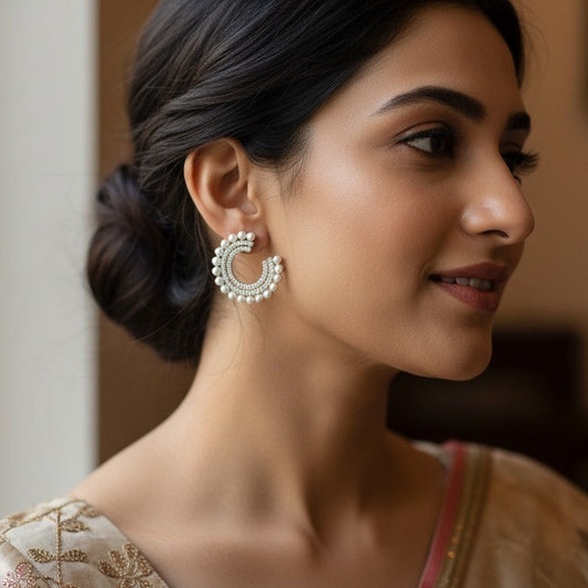 Woman wearing elegant earrings with a blurred background