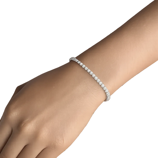 Silver bracelet on a wrist against a white background