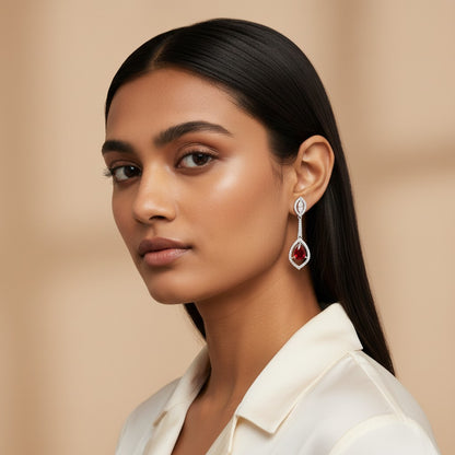 Woman wearing a pair of earrings with a beige background