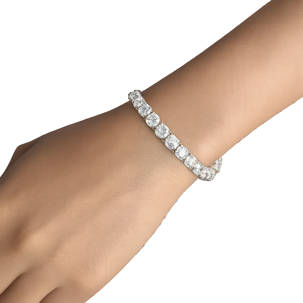Silver bracelet with clear stones on a wrist against a white background