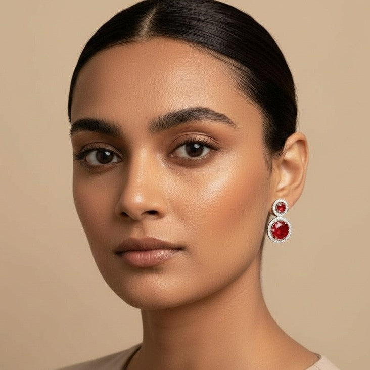 Woman wearing earrings with a beige background