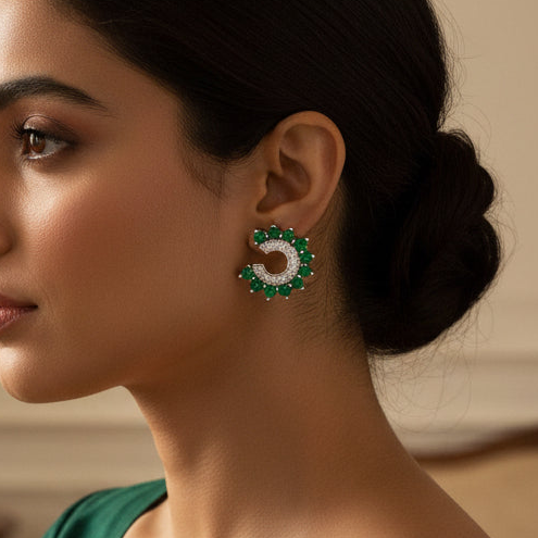Woman wearing a green saree with gold details in an elegant room.